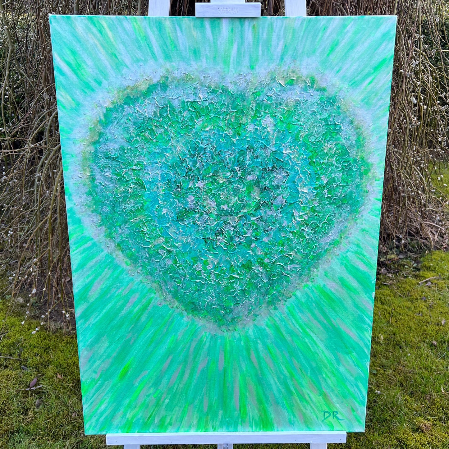 textured painting of emerald green heart emitting rays of ligth