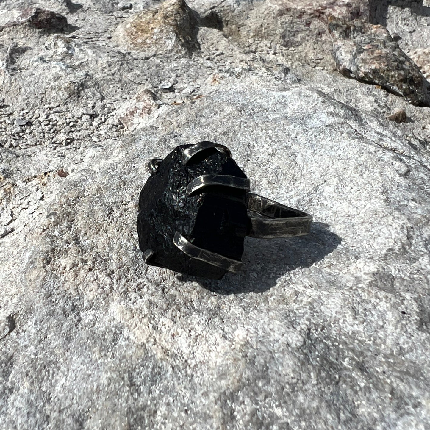 black tourmaline ring in oxidized sterlingsilver on concrete surface