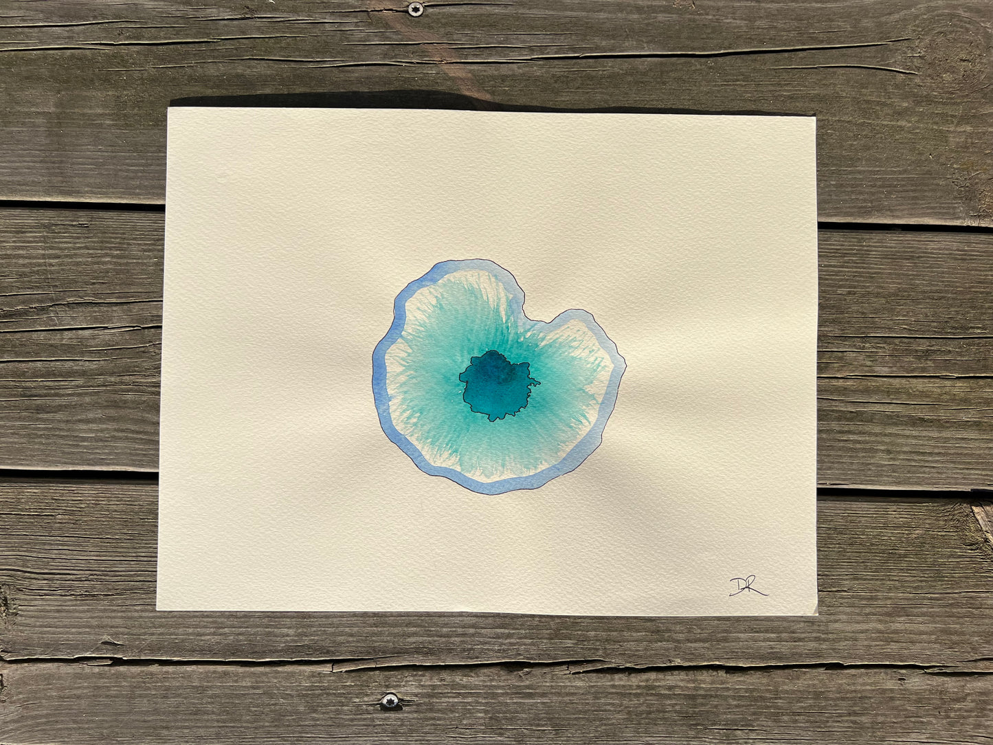 watercolor painting A4 of a blue and turquoise eye on beige fabriano paper