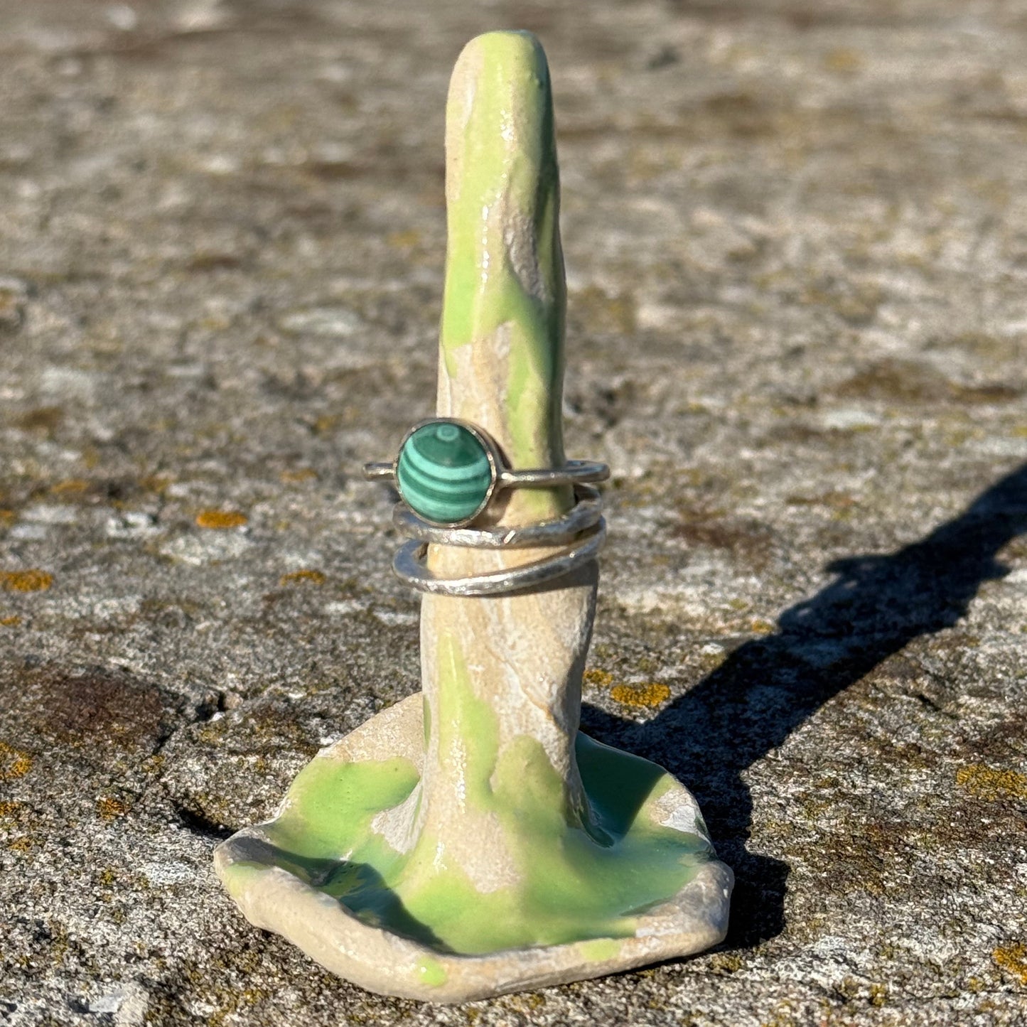 lime green ceramic ring cone with silver malachitee rings and a stack of silverrings
