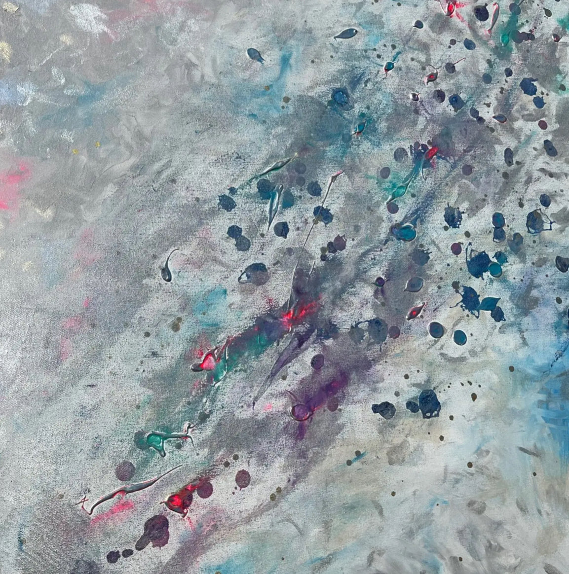 Abstract art with splashes of red, blue, and black on a textured gray background
