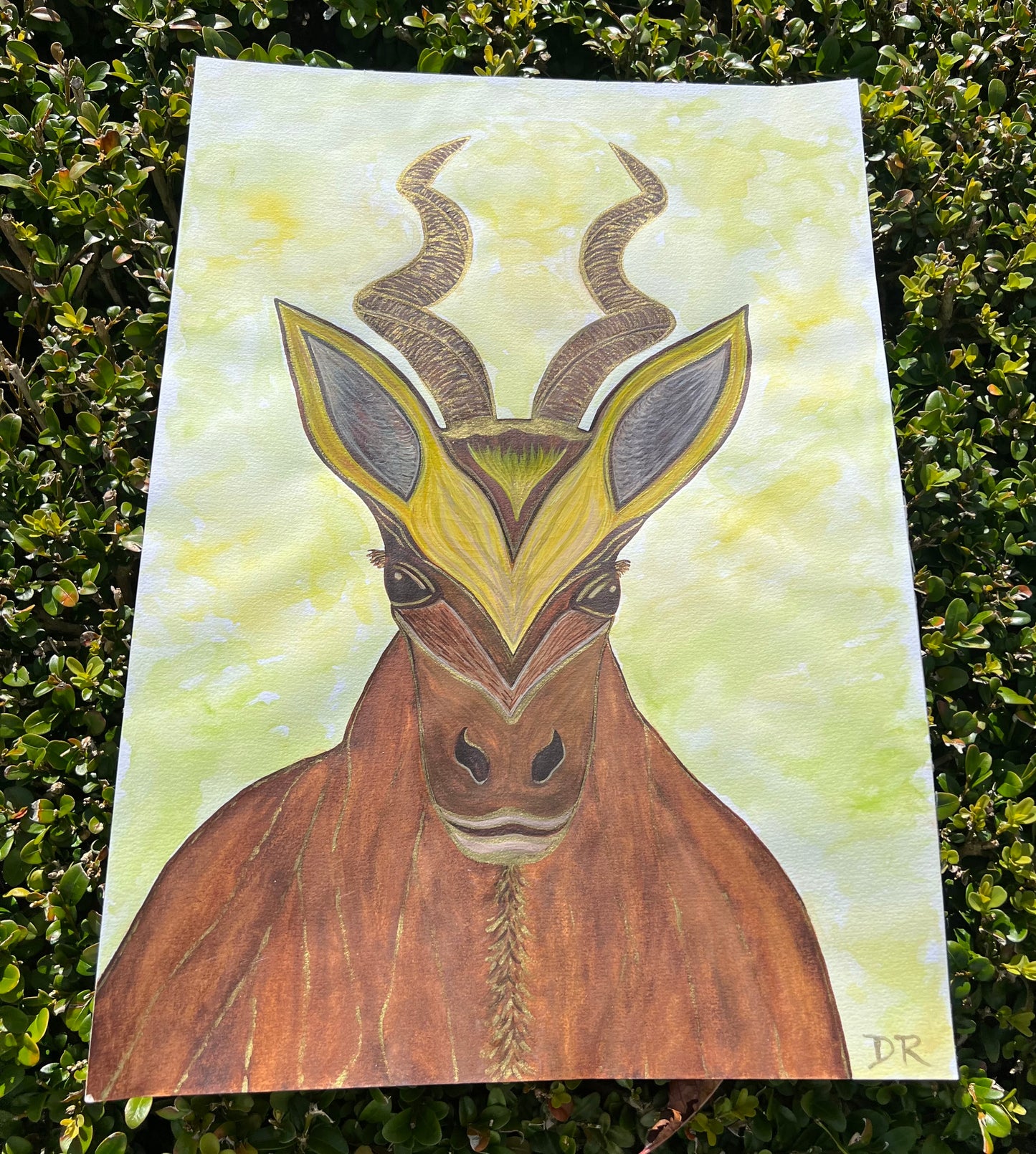 Artistic depiction of a fantasy deer with decorative patterns on the spiraled staghorns on a yellow background