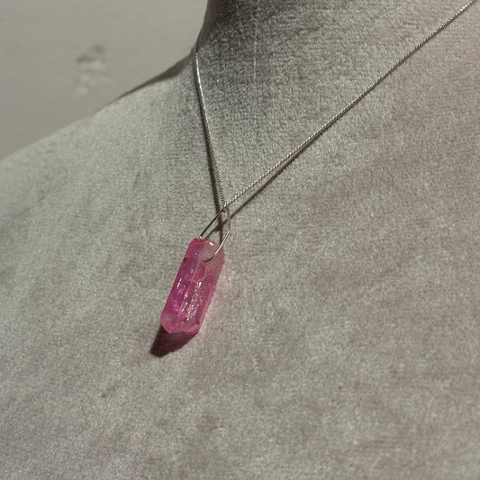 Pink crystal on a mannequin with a neutral background