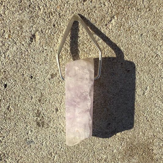lavender amethyst silver pendant on concrete