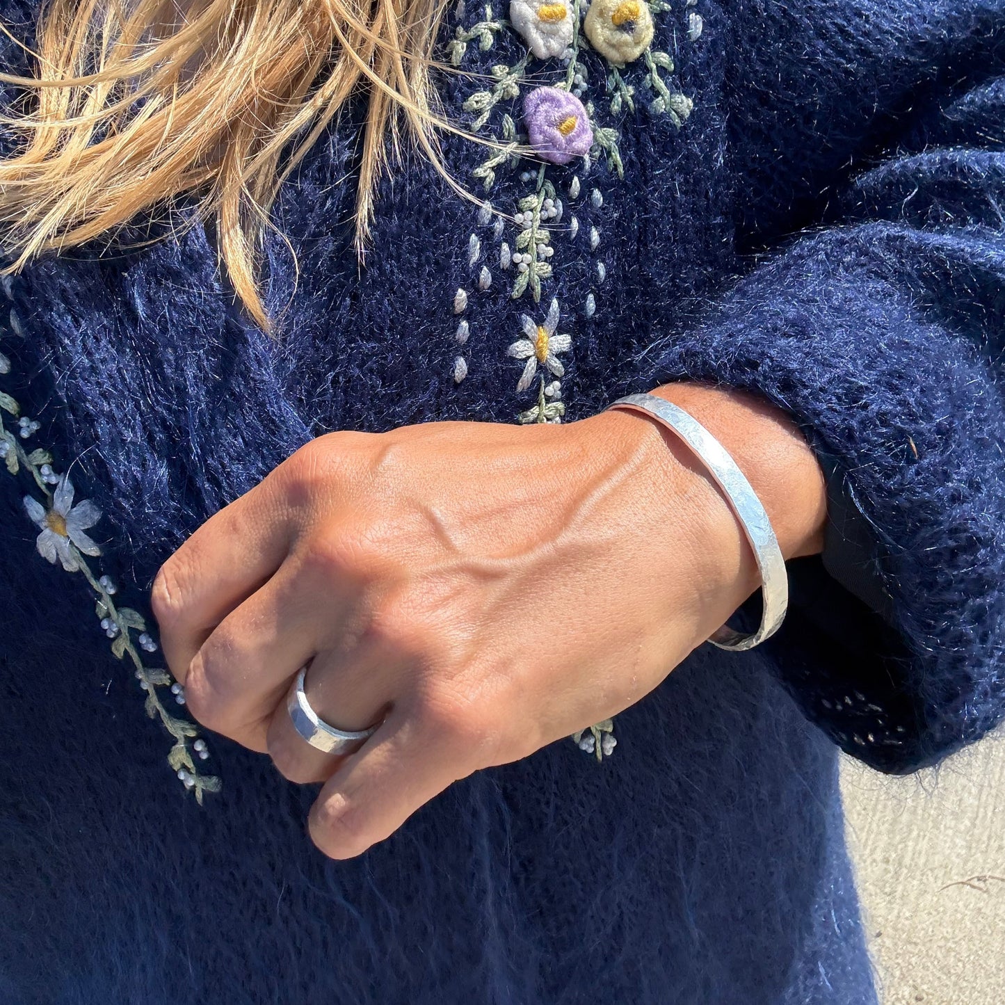 silver ring and silver cuff on a hand