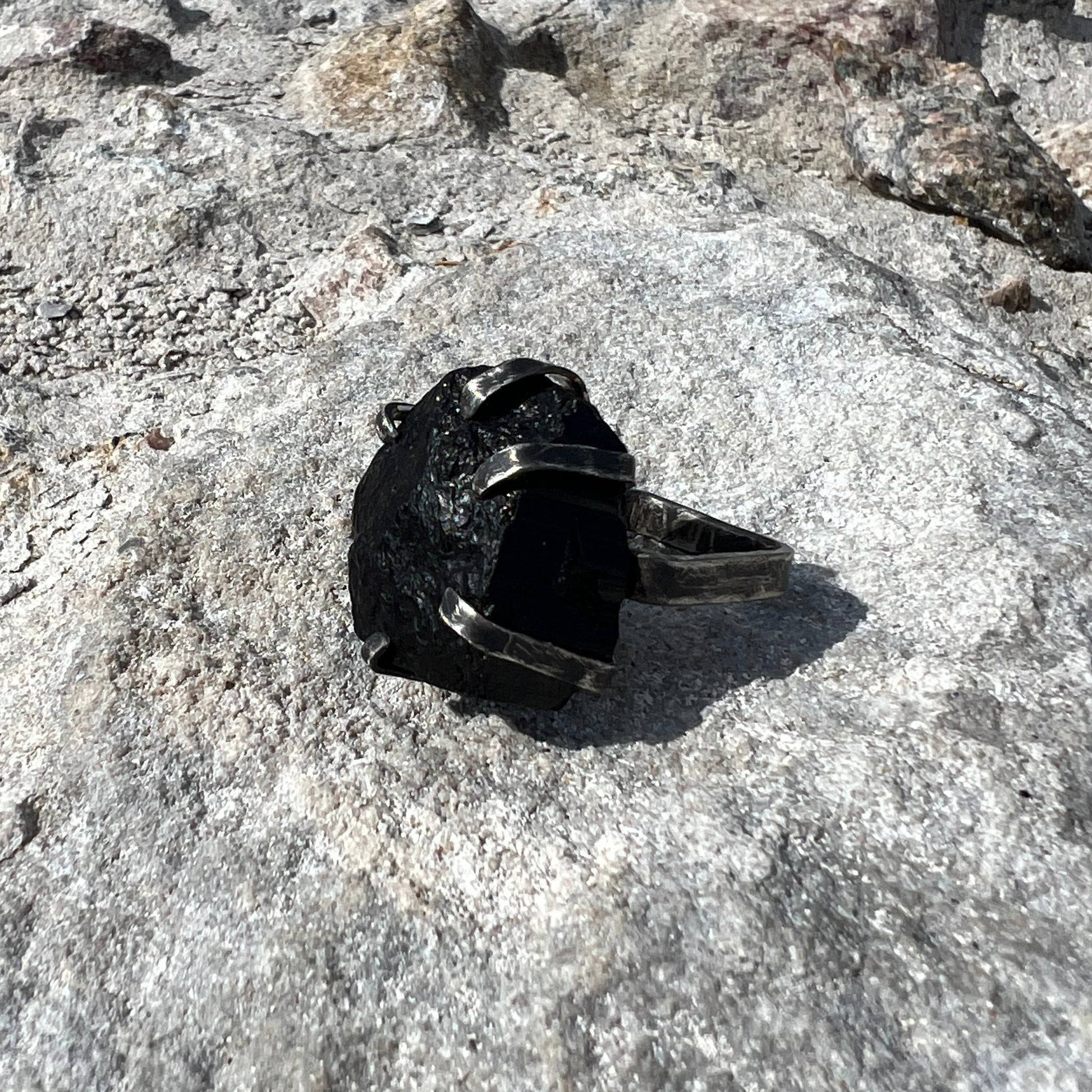 black tourmaline ring in oxidized sterlingsilver on concrete surface
