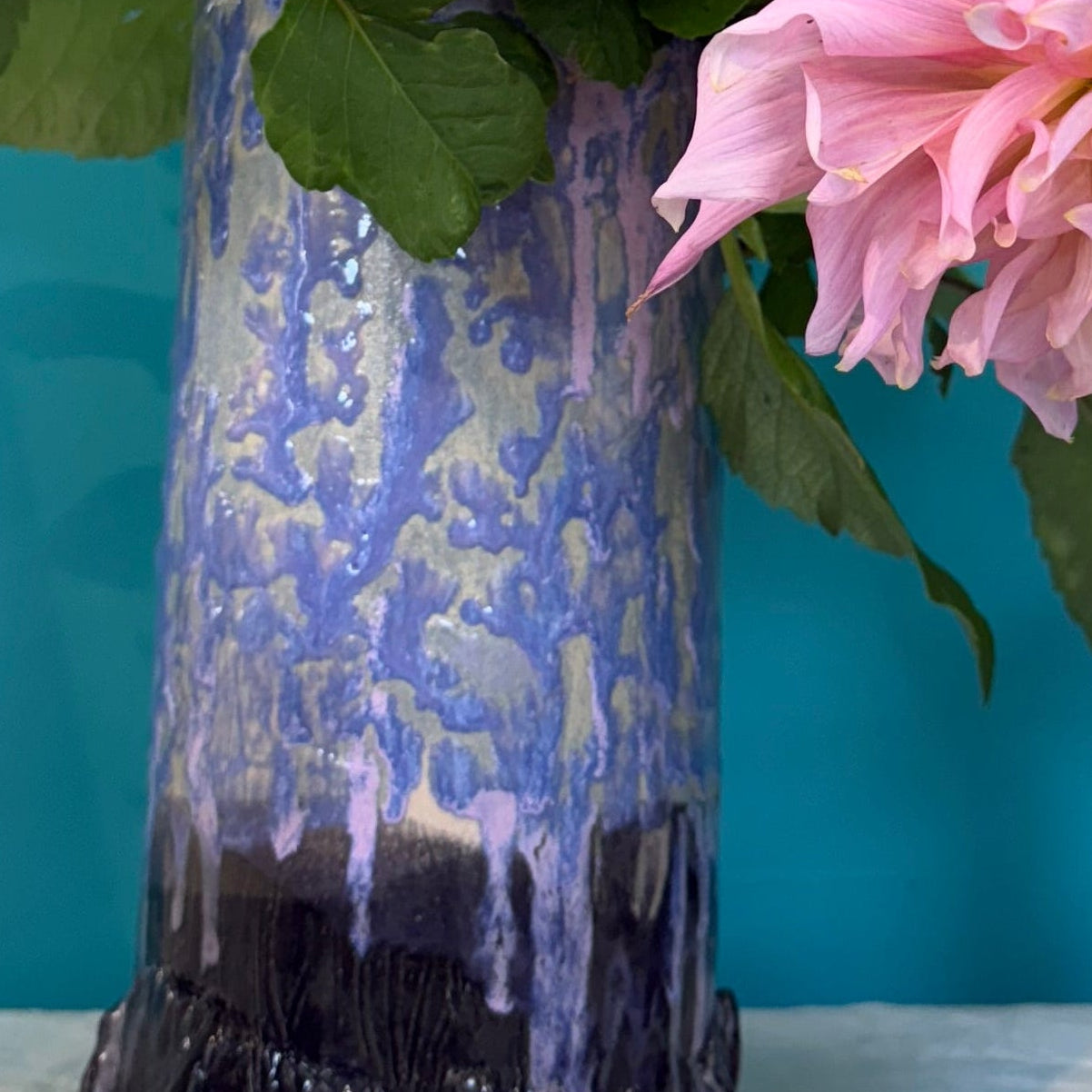 Pink dahlia flowers in a colorful mermaid ceramics vase.