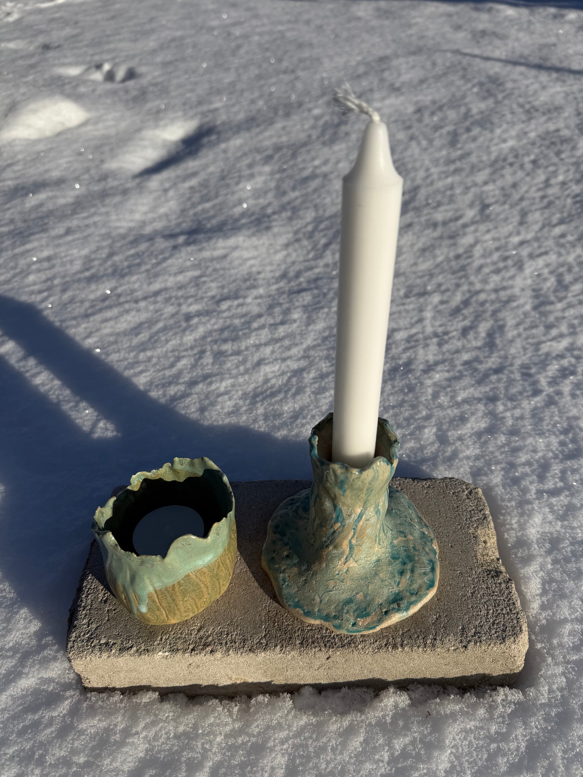 tea candle holder and candle holder in decorative ceramic holders on a textured surface