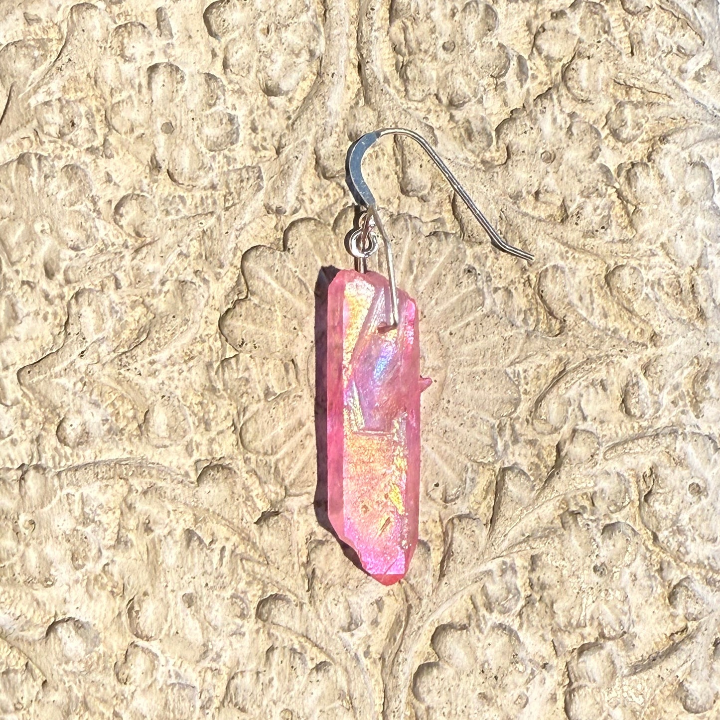Close-up of a a pink crystal earring 