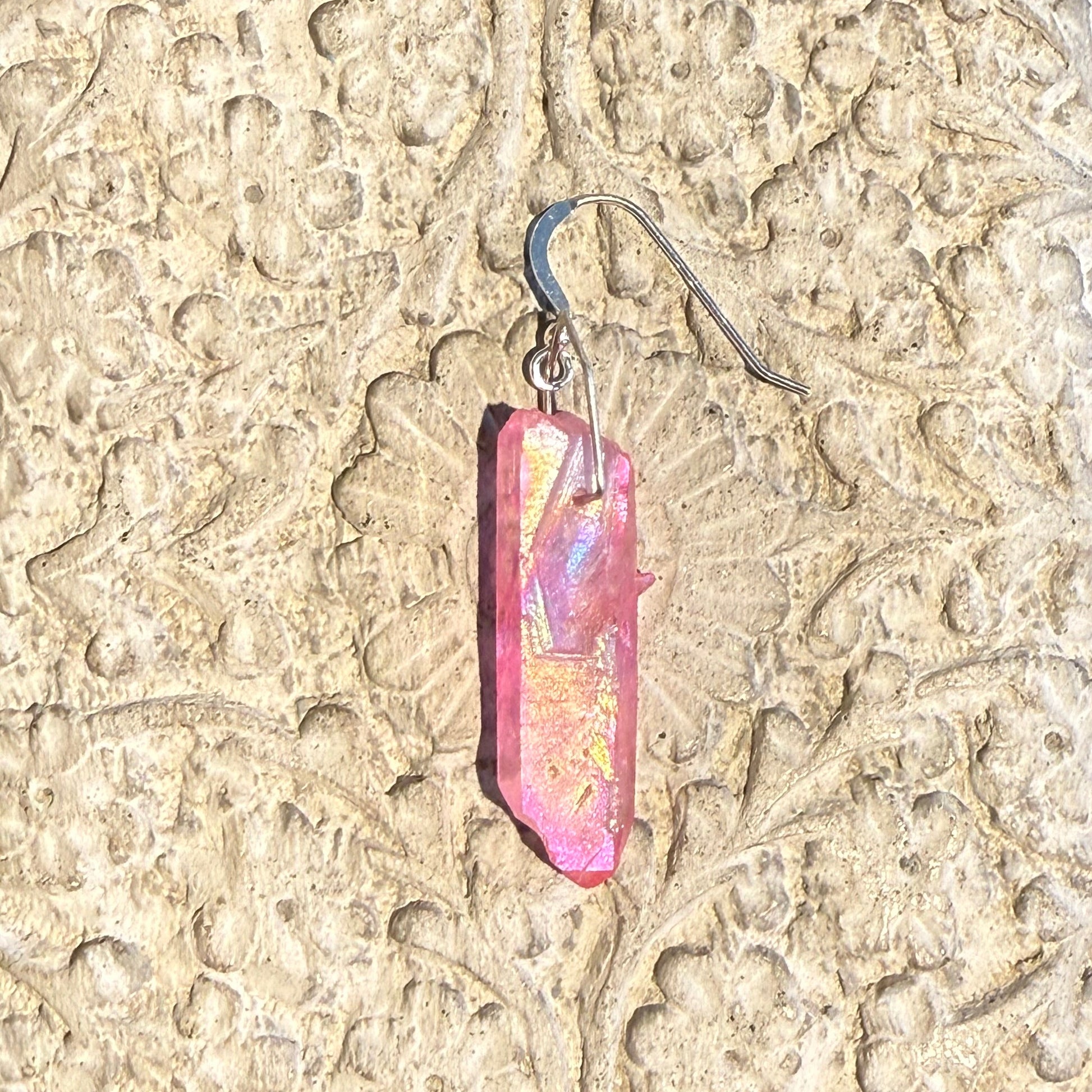 Close-up of a a pink crystal earring 