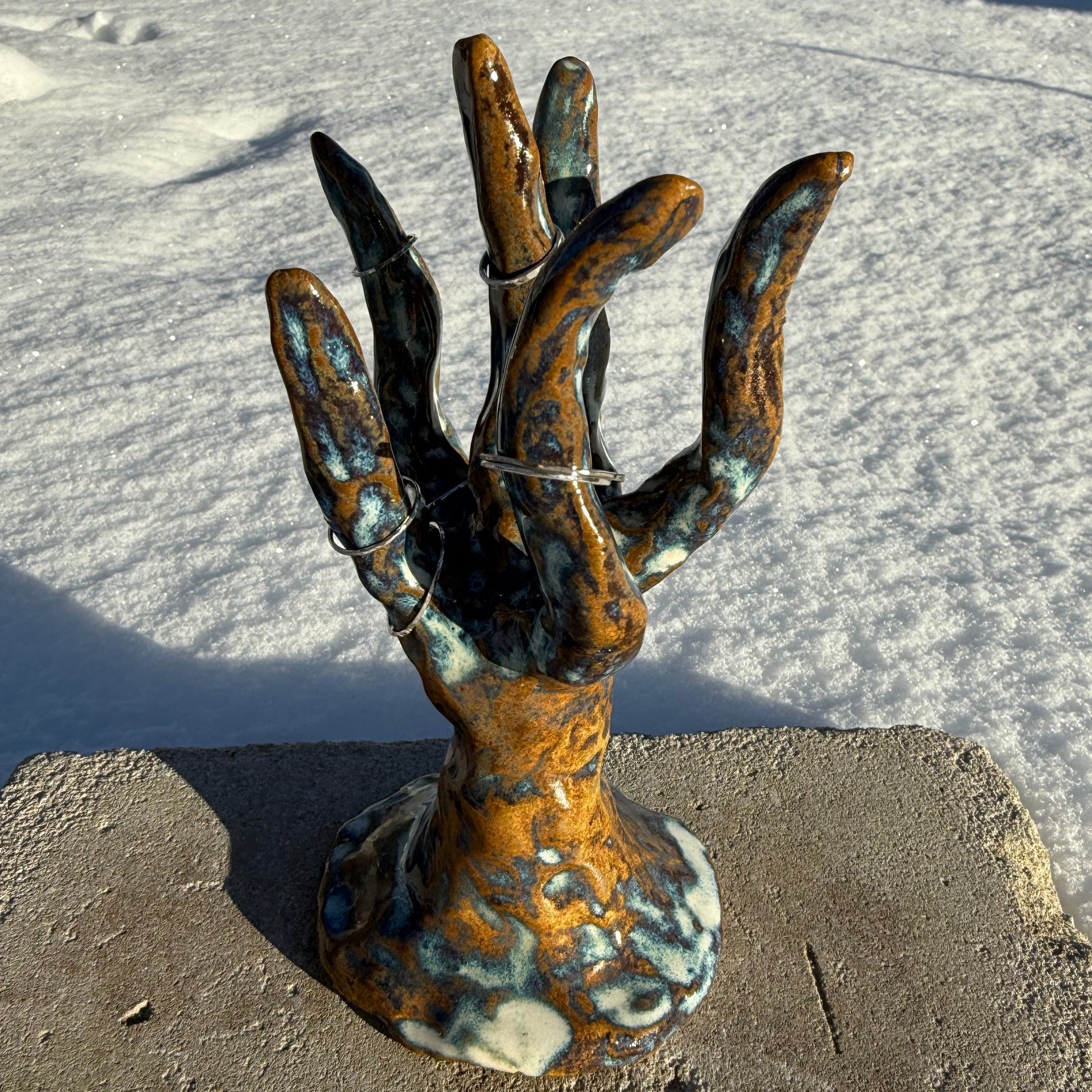 ceramic jewelry stand in the shape of a coral cluster on concrete and snowy background