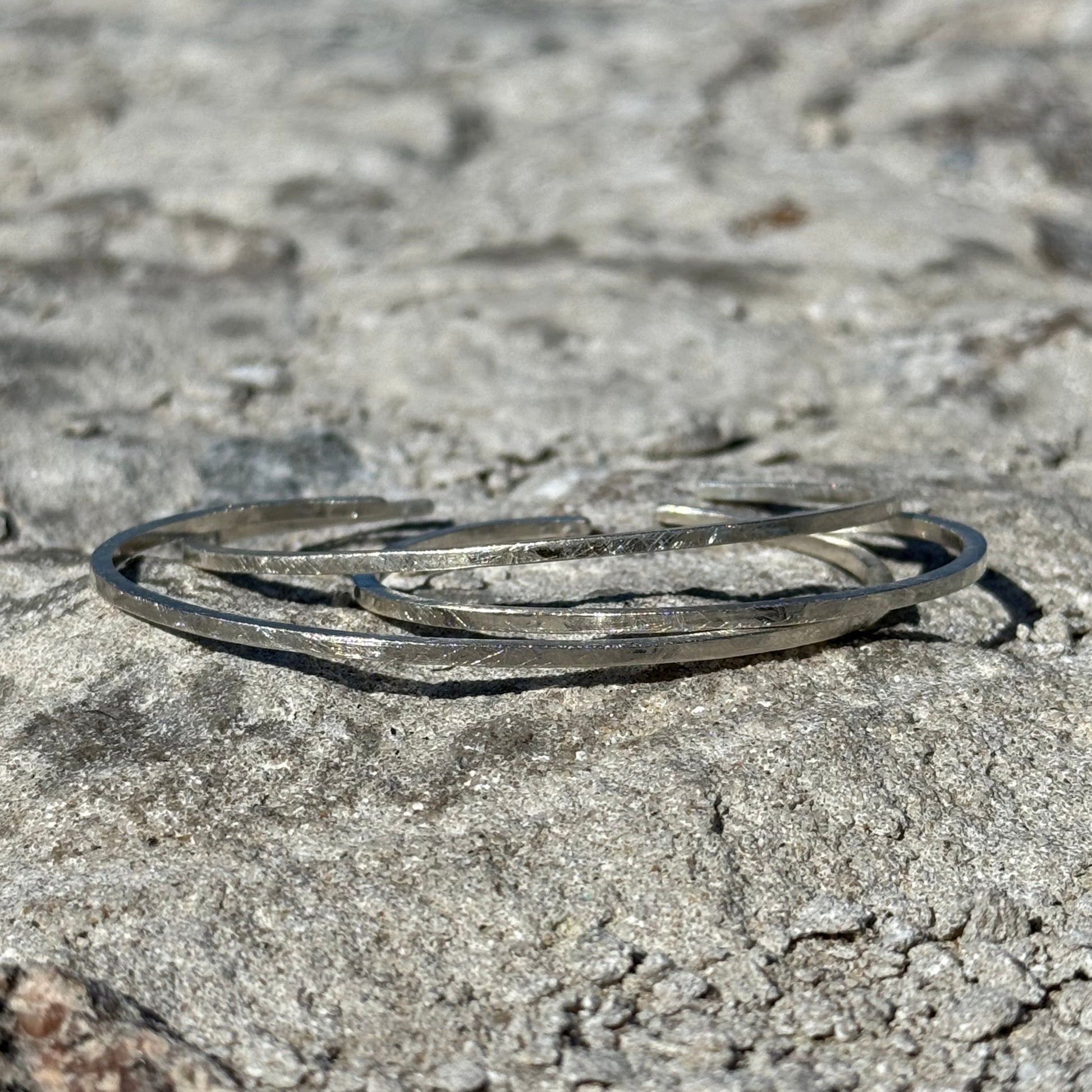 Silver bracelet on a textured stone surface