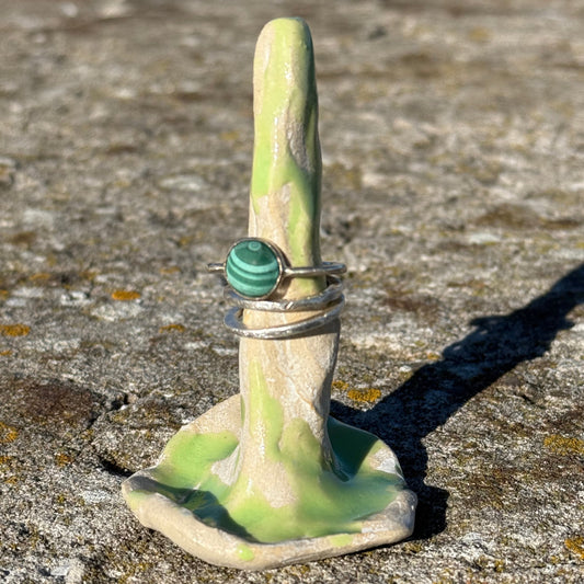 lime green ceramic ring cone with silver malachitee rings and a stack of silverrings