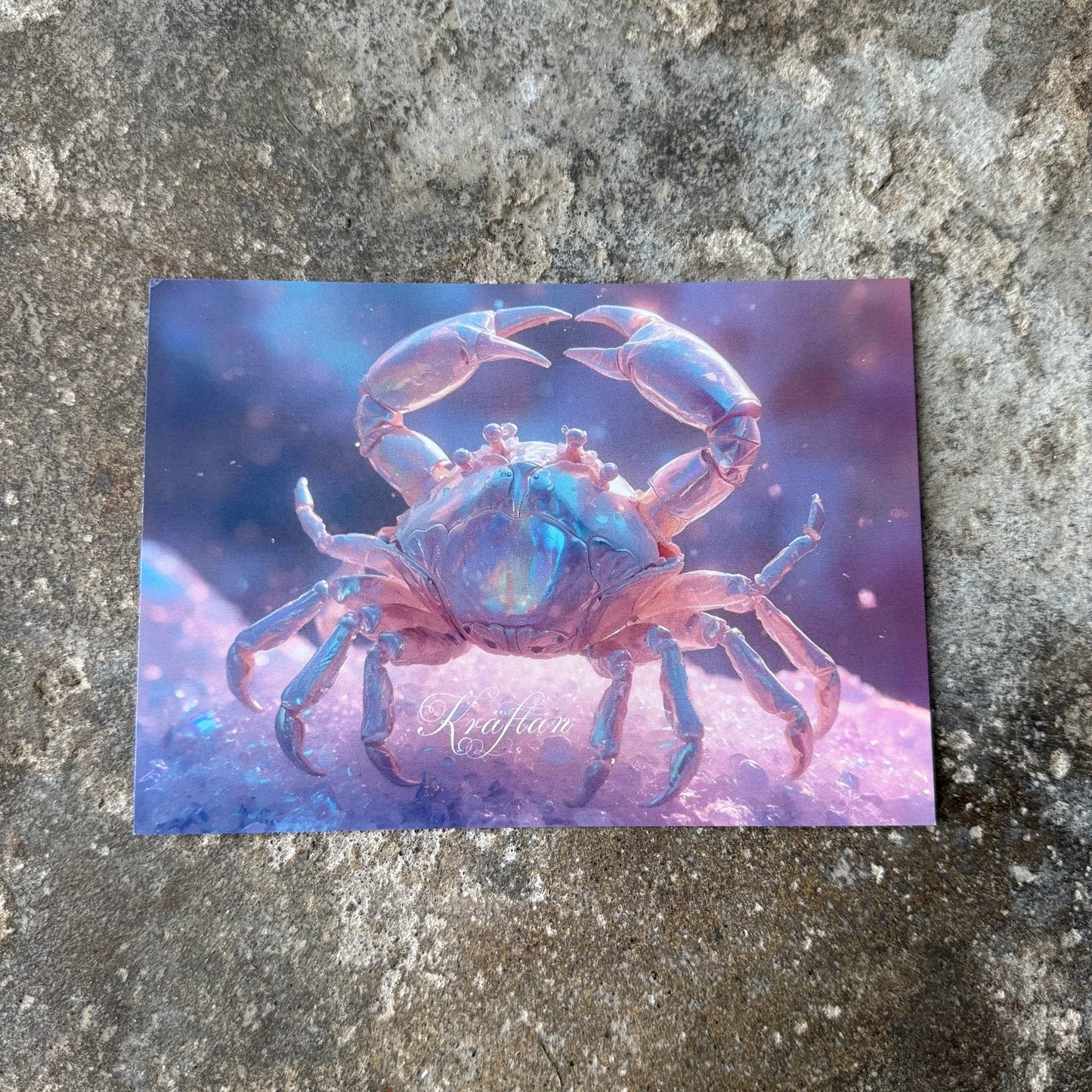 Postcard with a blue crab design on a textured surface for the star sign cancer spellede in swedish Kräftan