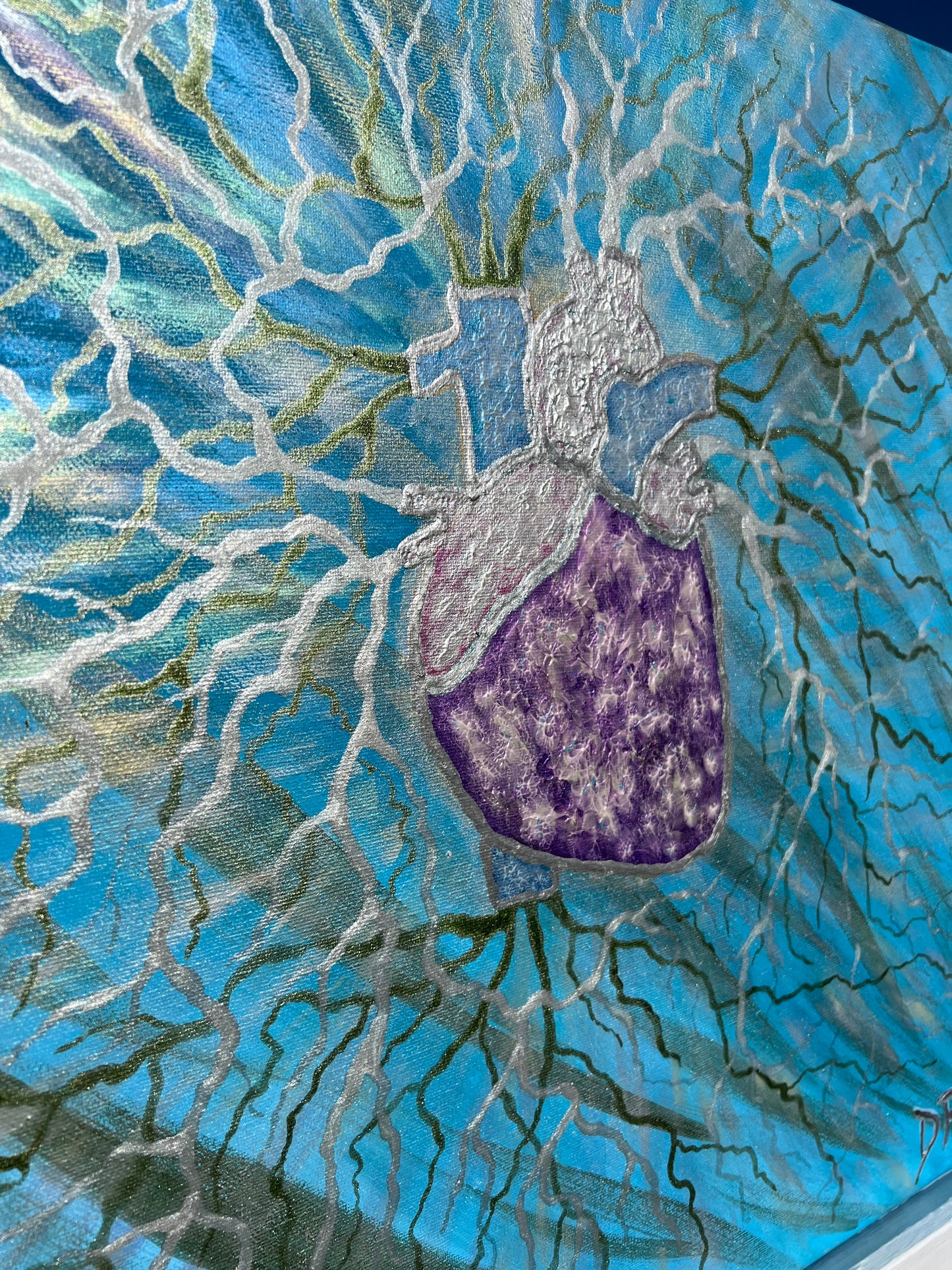 Mosaic artwork of a purple jmintakan heart on a blue and silvery background