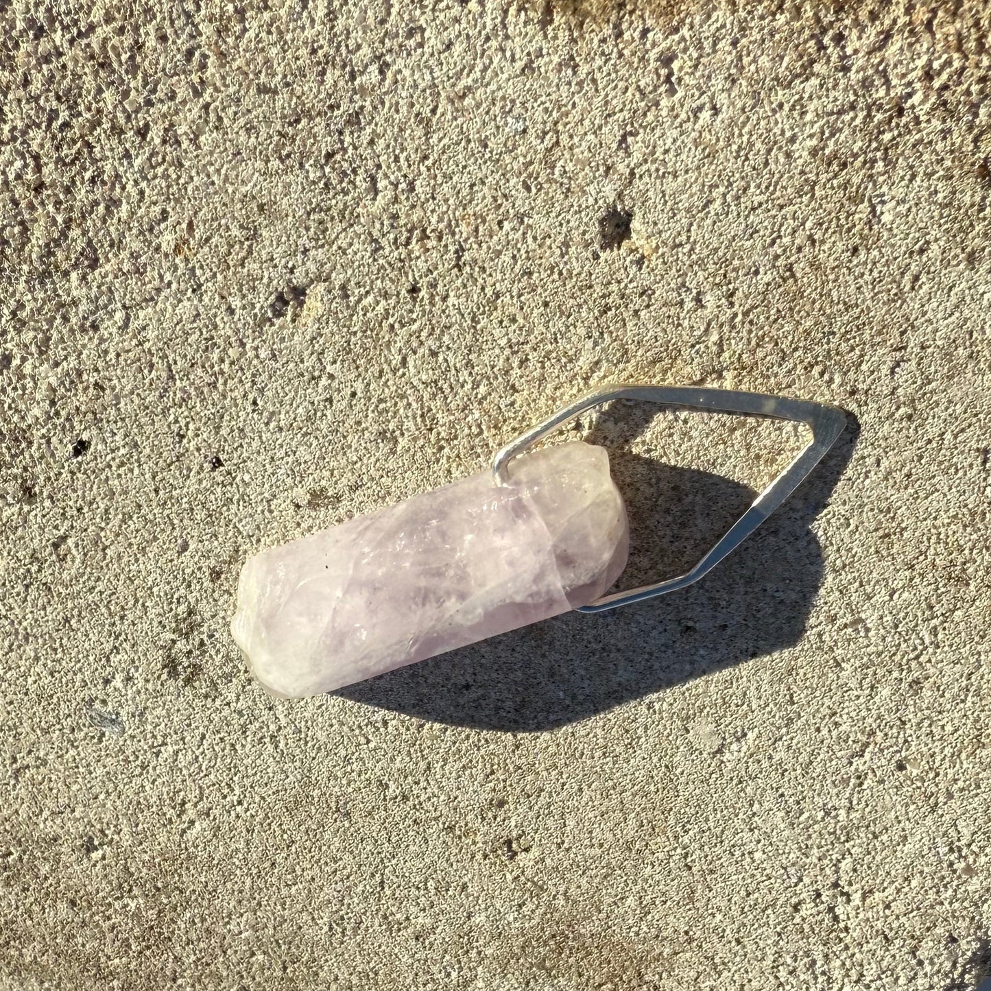 Crystal on a stone surface with snow in the background
