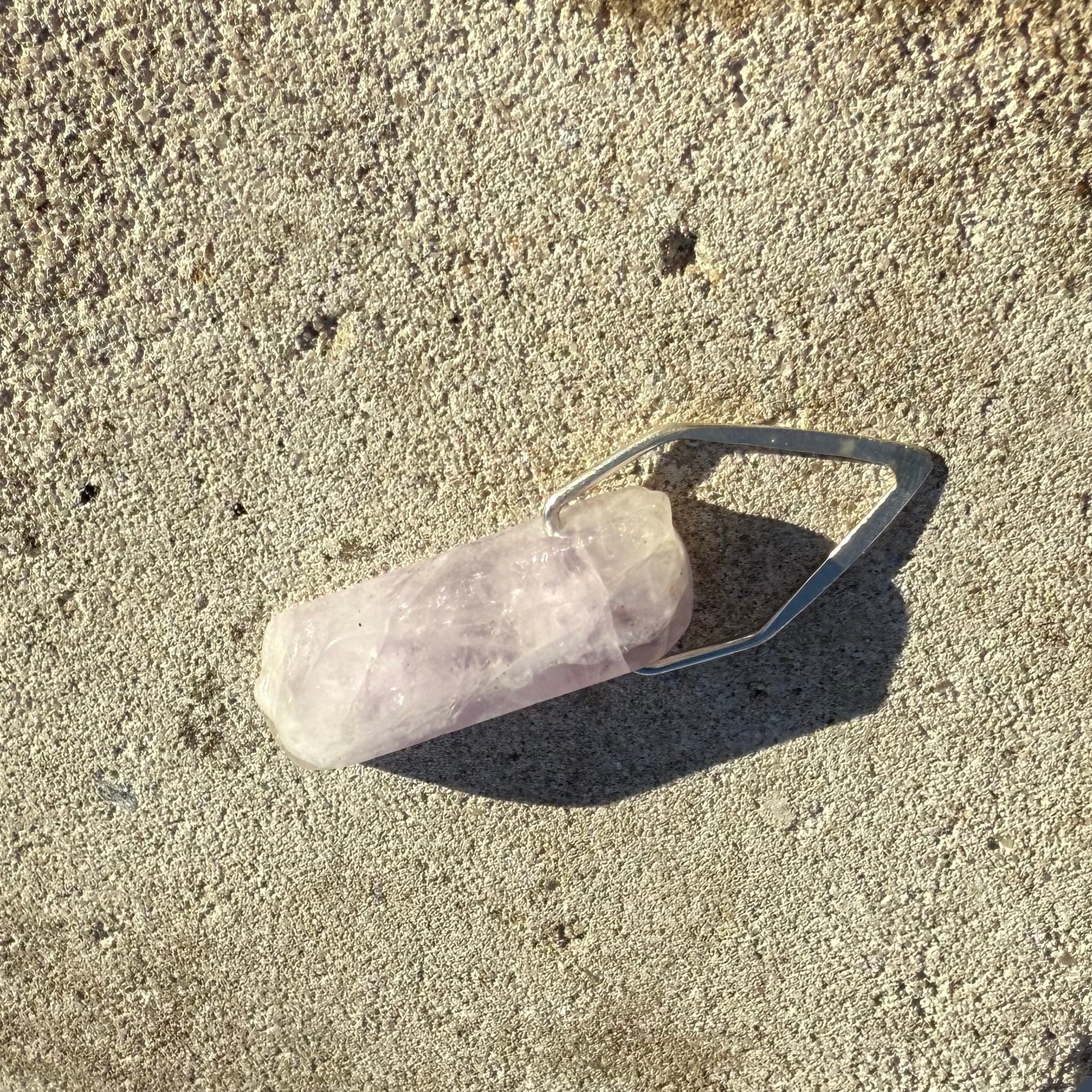 Crystal on a stone surface with snow in the background