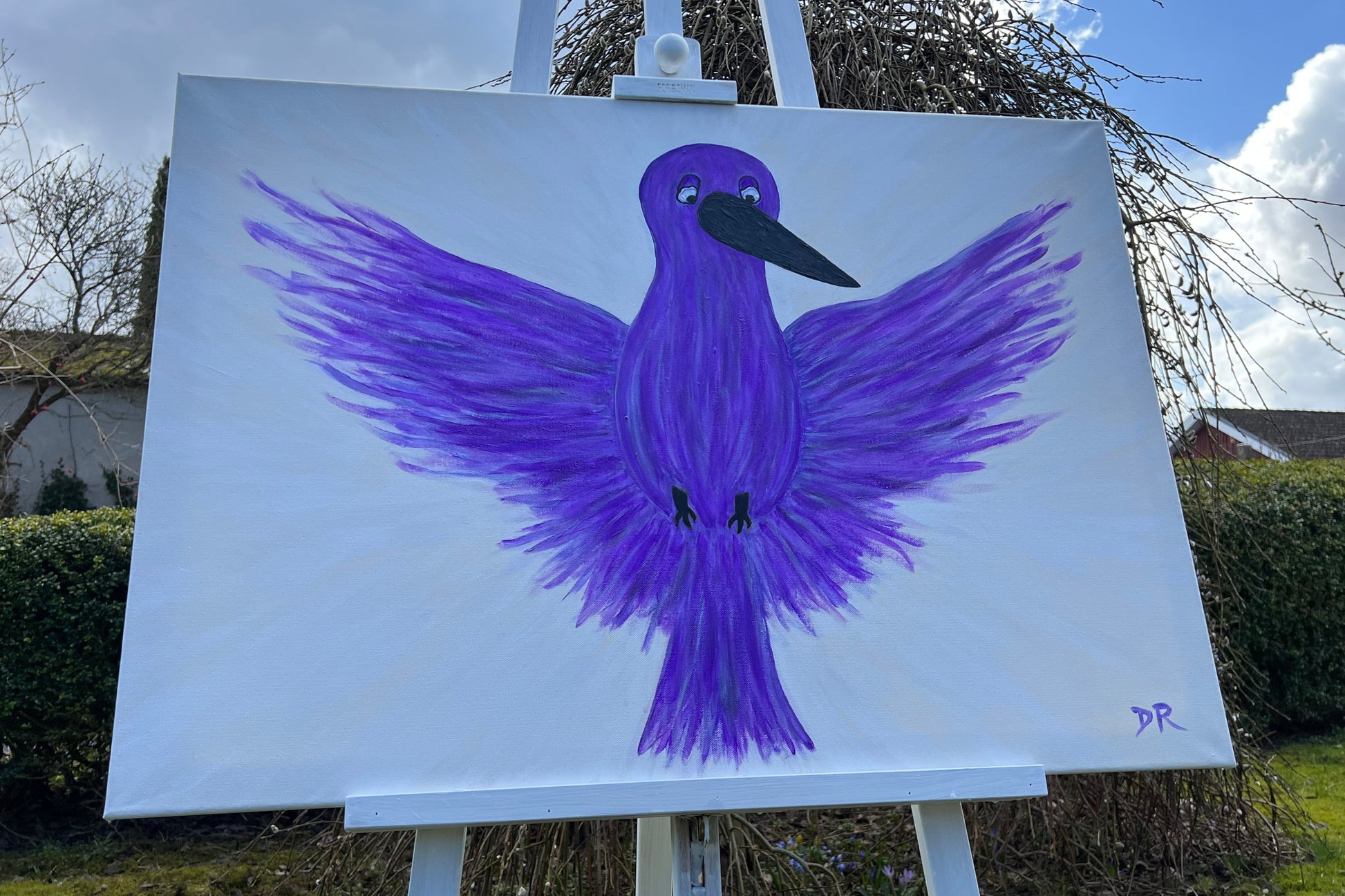 Purple bird painting with black beak and claws on a white canvas outdoors