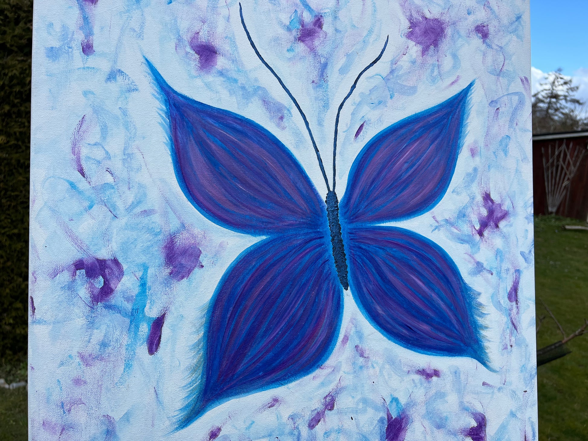 Painting of a blue butterfly on a canvas