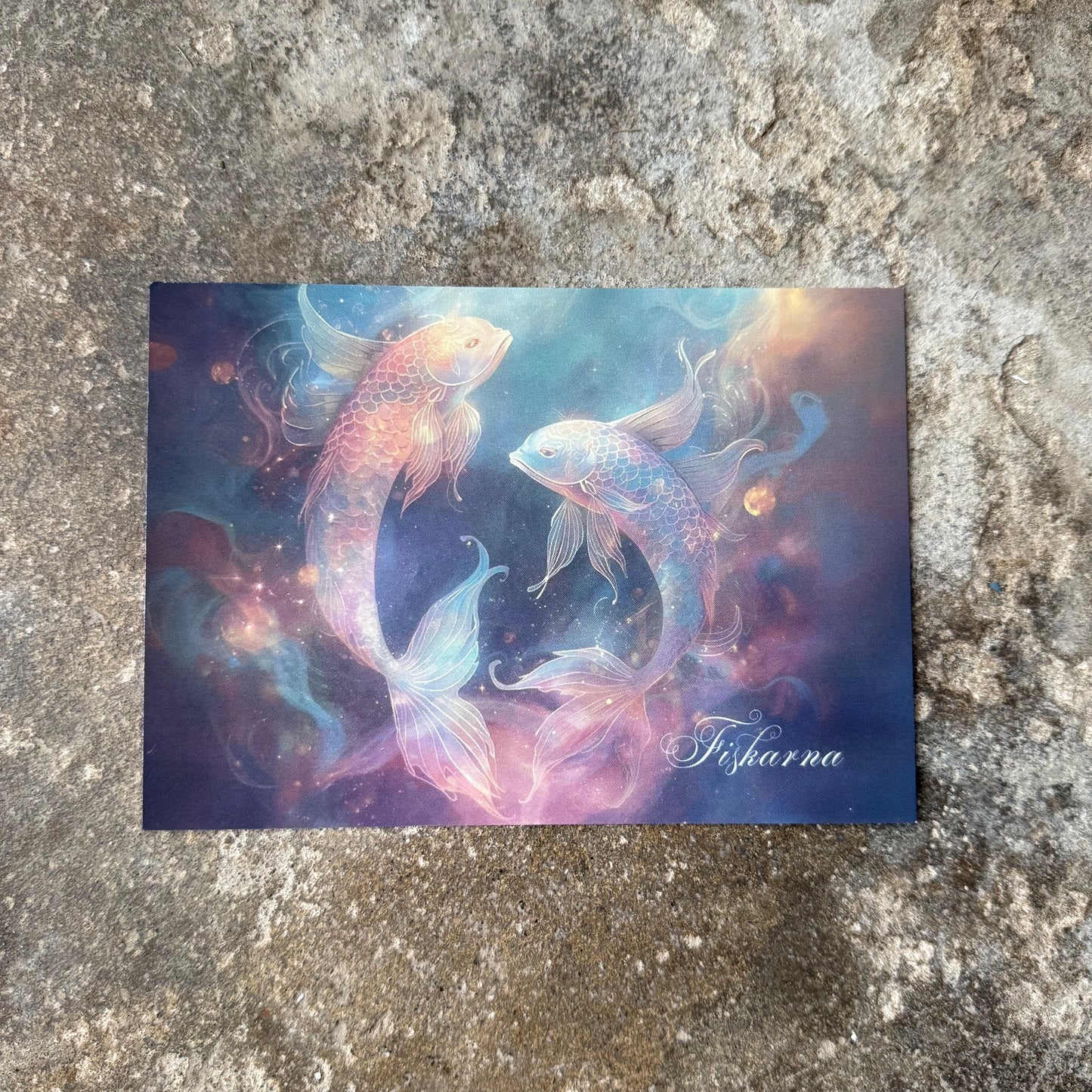 postcard of star sign and zodiak sign pisces on a textured stone surface