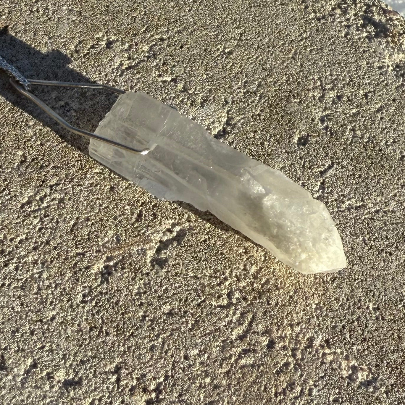 clear quartzCrystal or mineral on a textured concrete surface