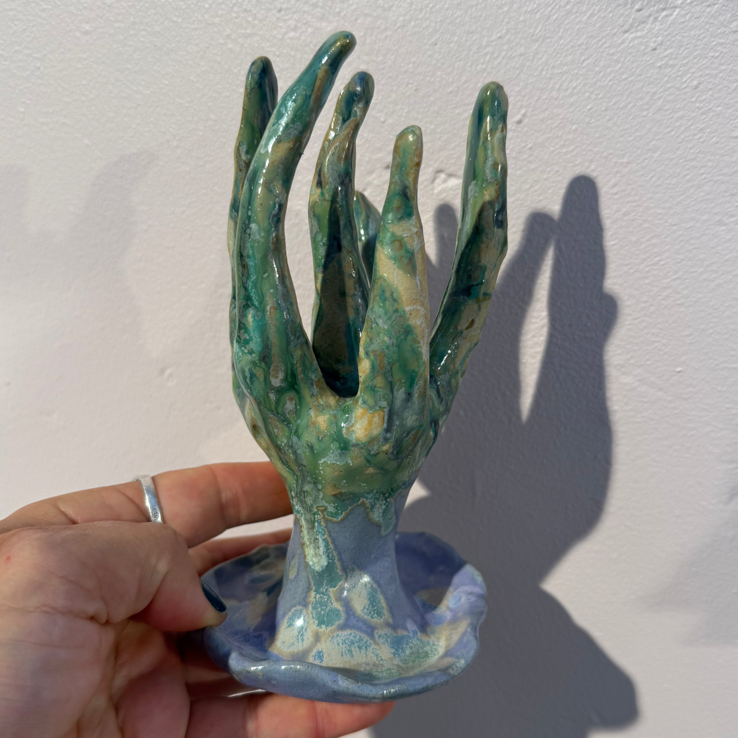 ceramic jewelry stand on soft pink background